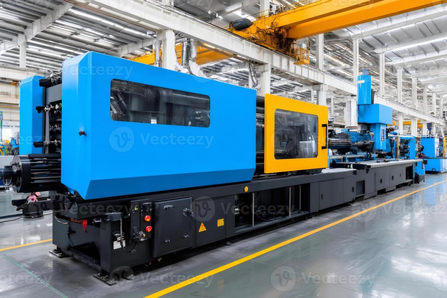 Plastic injection molding machine operating in a modern factory photo