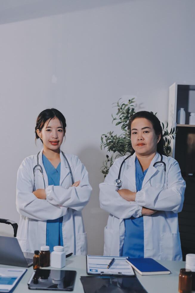 Two female doctors standing in front of a desk photo