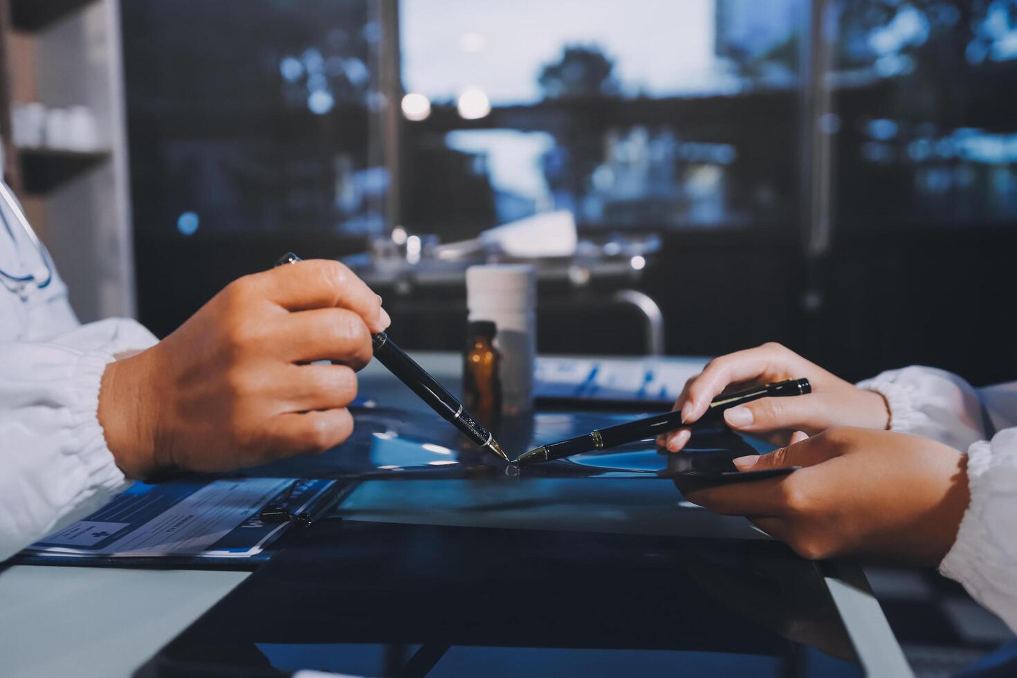 Two people working on a laptop with scissors photo