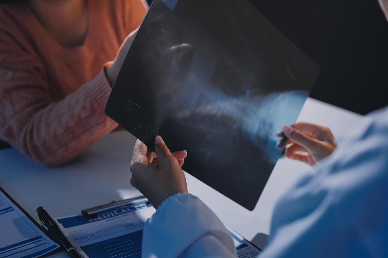 A woman is holding a x - ray on a table photo