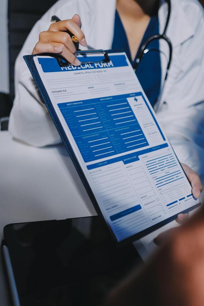 A doctor is writing on a clipboard with a patient photo
