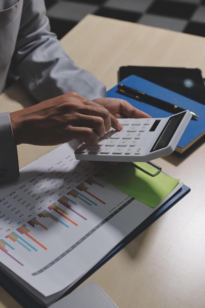 A person using a calculator to do some calculations photo