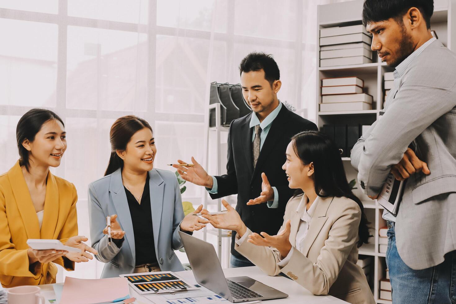 A group of business people talking and laughing photo