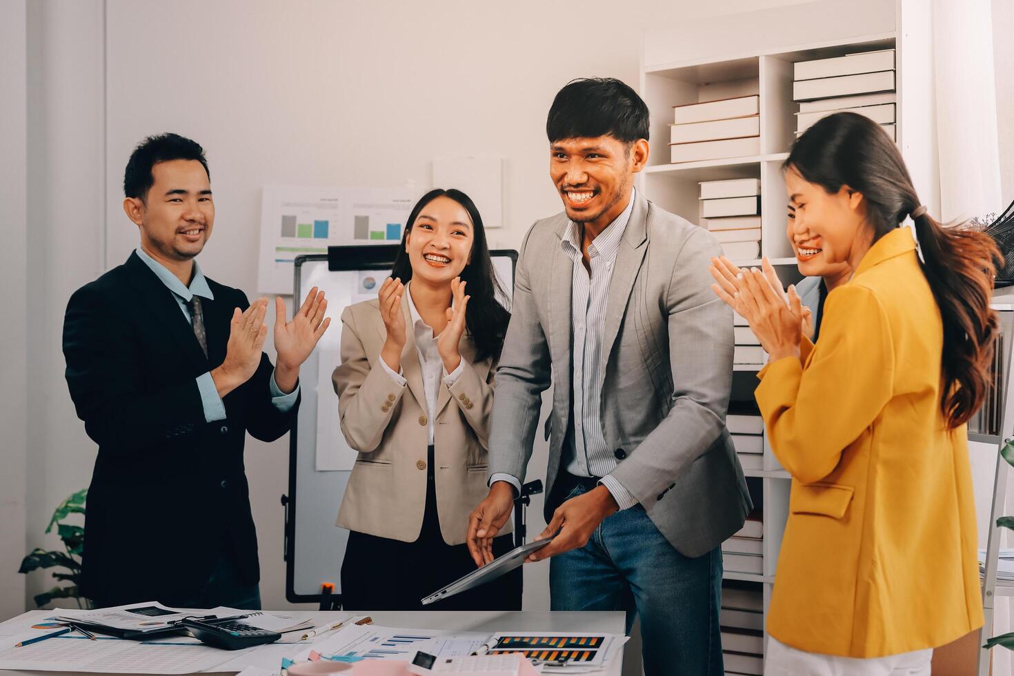 Business people clapping and smiling at each other photo