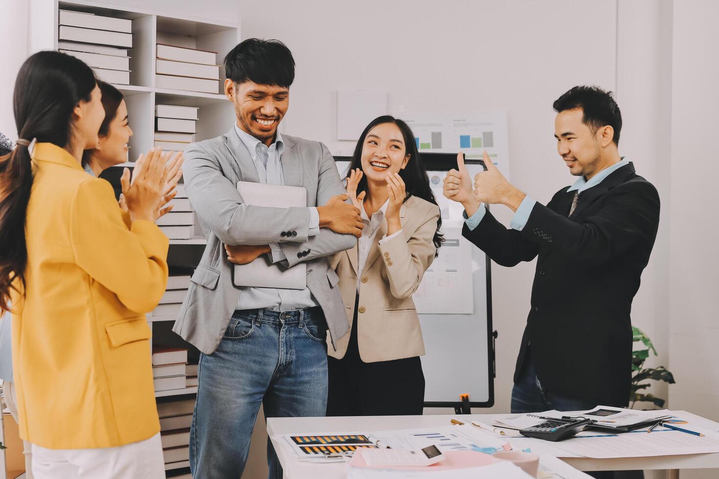 Business people clapping and smiling in an office photo