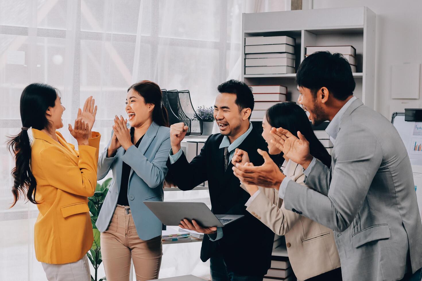 Business people clapping and cheering in an office photo