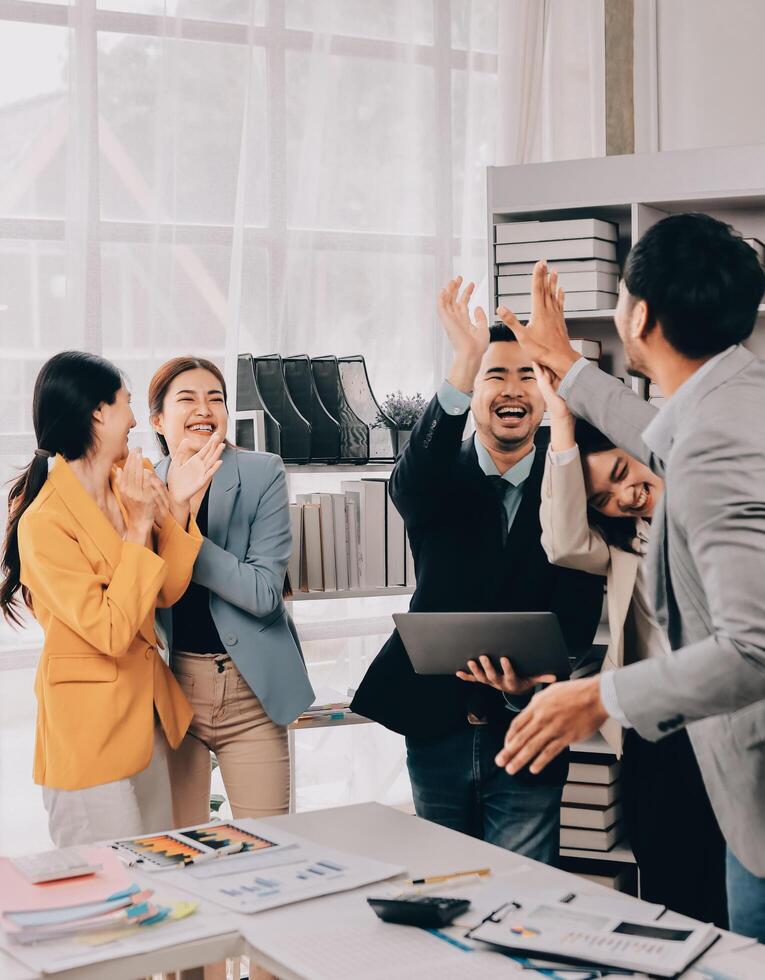 Business people clapping and celebrating in office photo