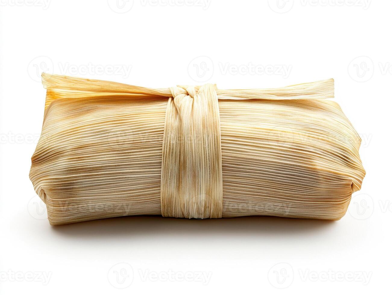 Delicious tamale wrapped in corn husks ready for serving photo