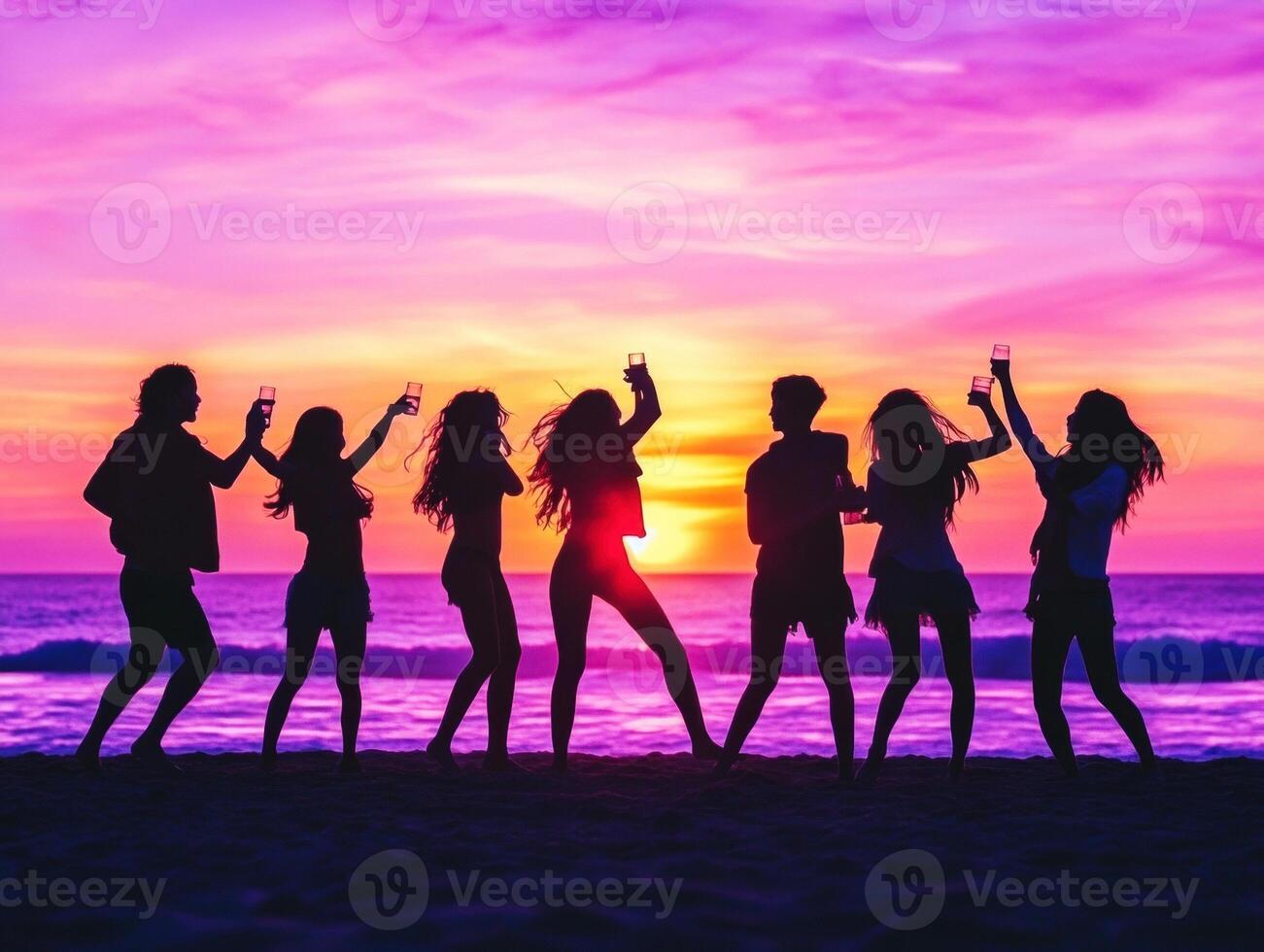 Friends celebrate sunset with drinks at beach photo