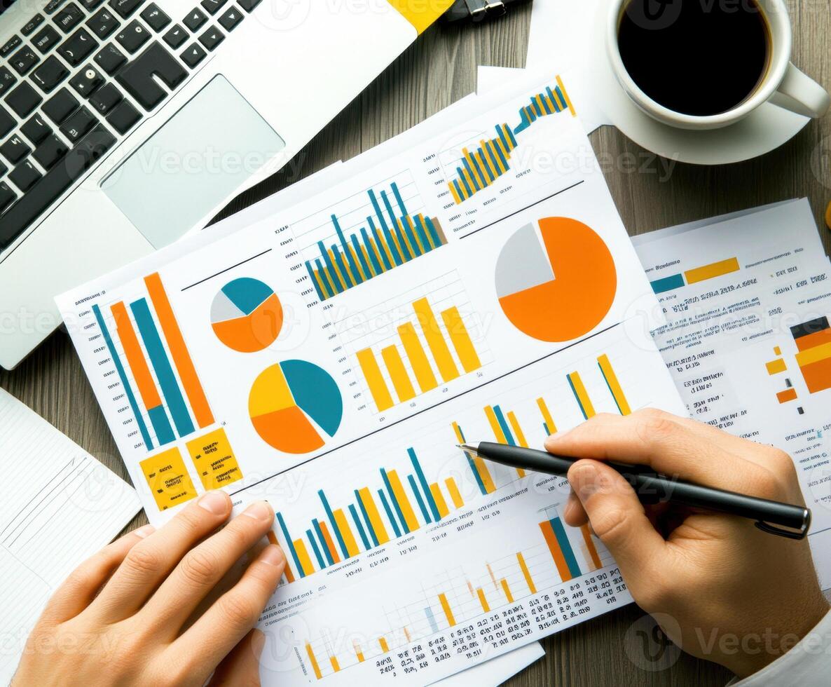Analyzing business reports with charts and graphs at a desk photo