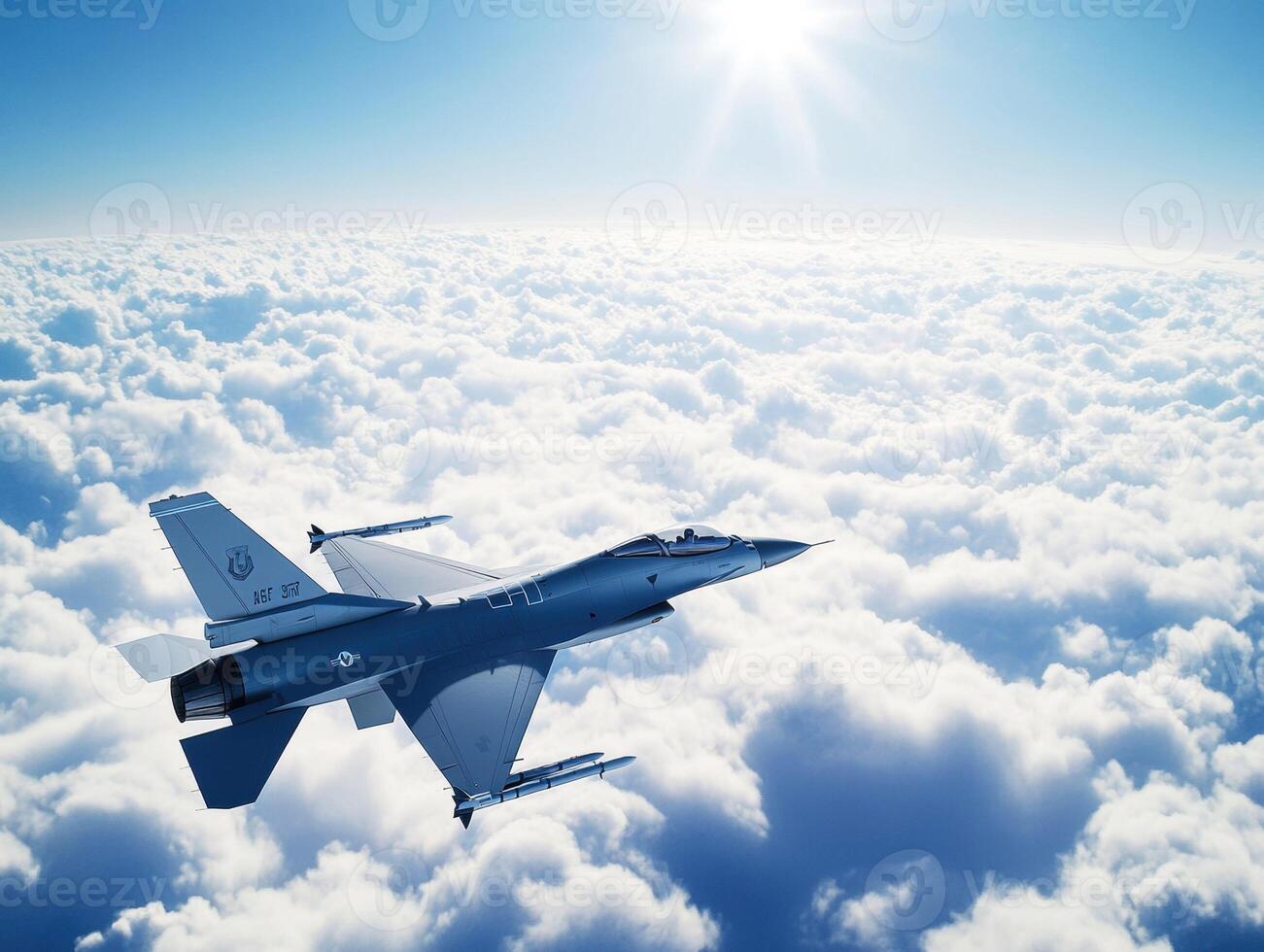 Military jet flying above fluffy clouds in a clear blue sky photo