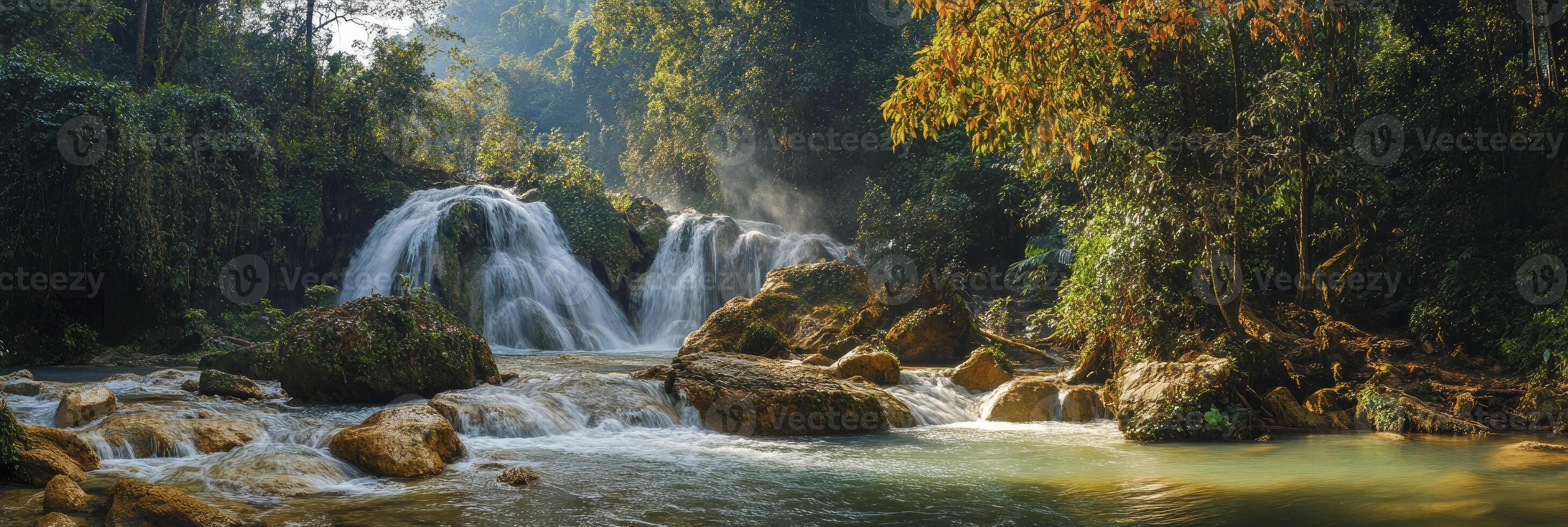 Waterfall in the jungle with rocks and trees photo