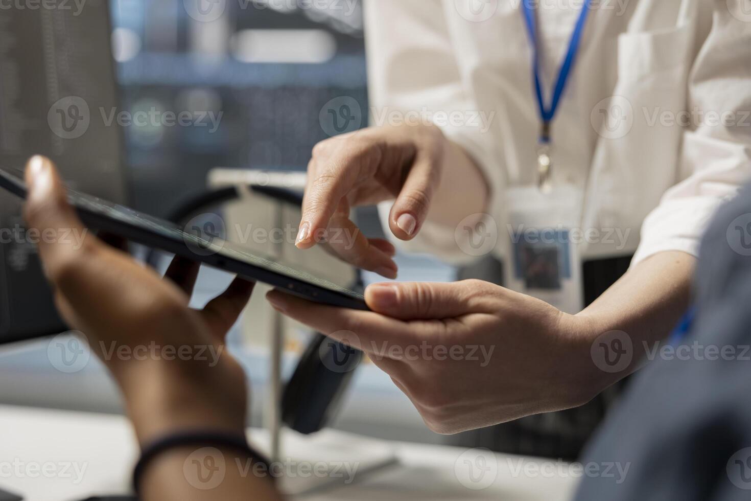 Data center engineering team analyzing software logs metrics on tablet, optimizing storage systems. Close up of server farm coworkers inspecting resource utilization on device photo