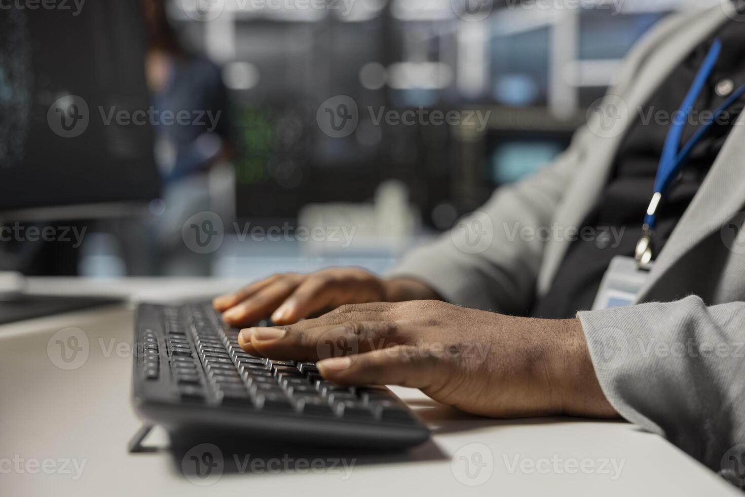 Close up of data center technician typing on keyboard, inspecting gear, doing maintenance tasks. Server farm employee coding on PC, conducting system checks to ensure operational stability photo