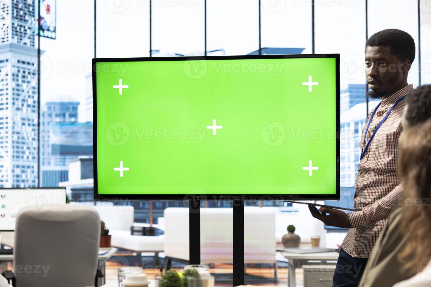 Diverse group of startup employees looking at green screen on an interactive board, meeting to discuss ideas and details to ensure organizational progress. Forecast affiliates in office. photo