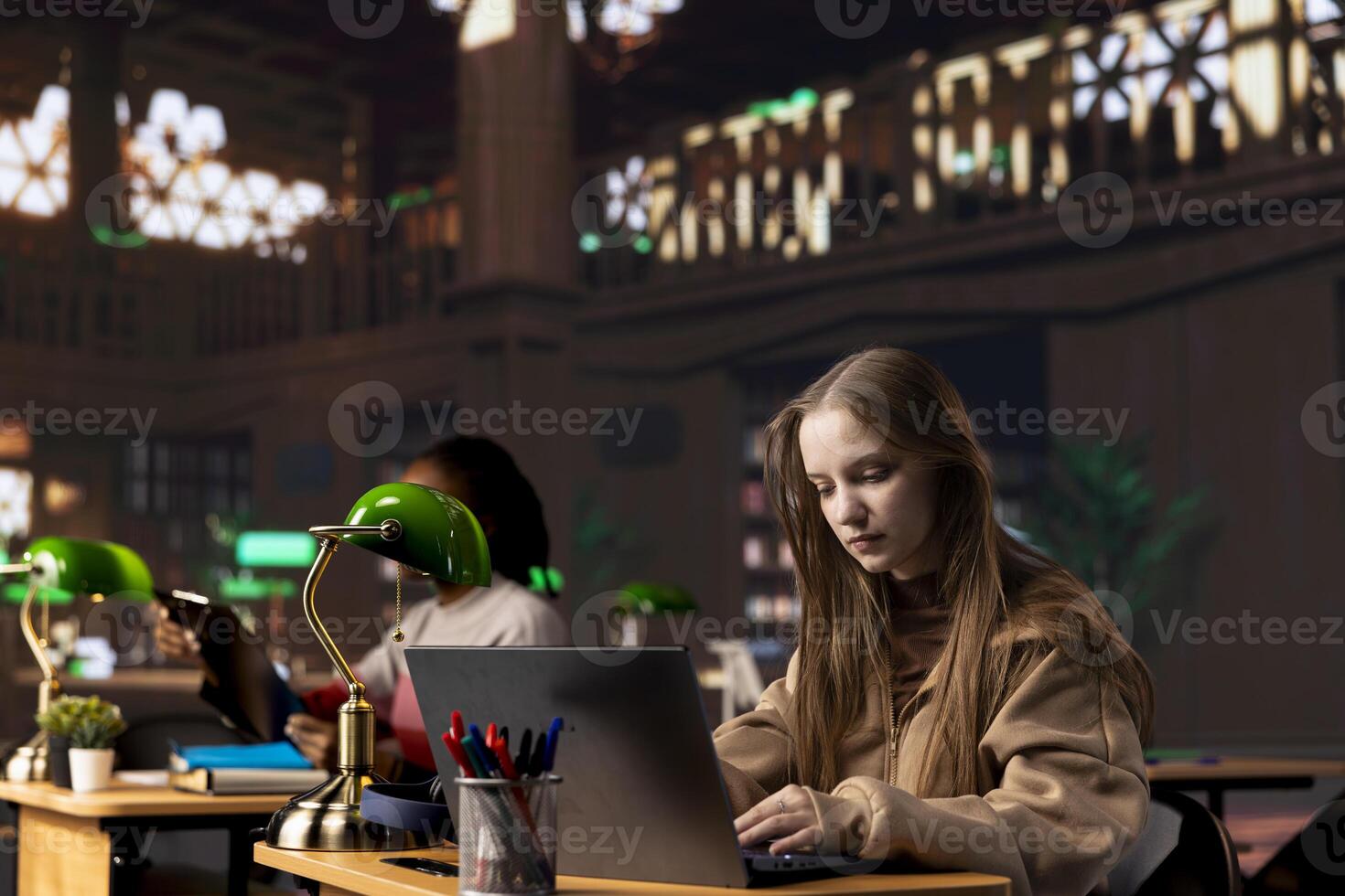 College student captivated by her literature assignment at the academic library on campus, working on her bachelor degree paperwork. Uses primary source materials from the general database. photo