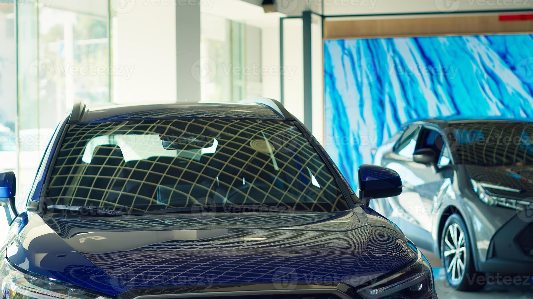 Panning shot of showcased cars with sleek design in showroom waiting to be purchased by interested customers. Modern vehicle models in dealership being advertised for potential buyers photo