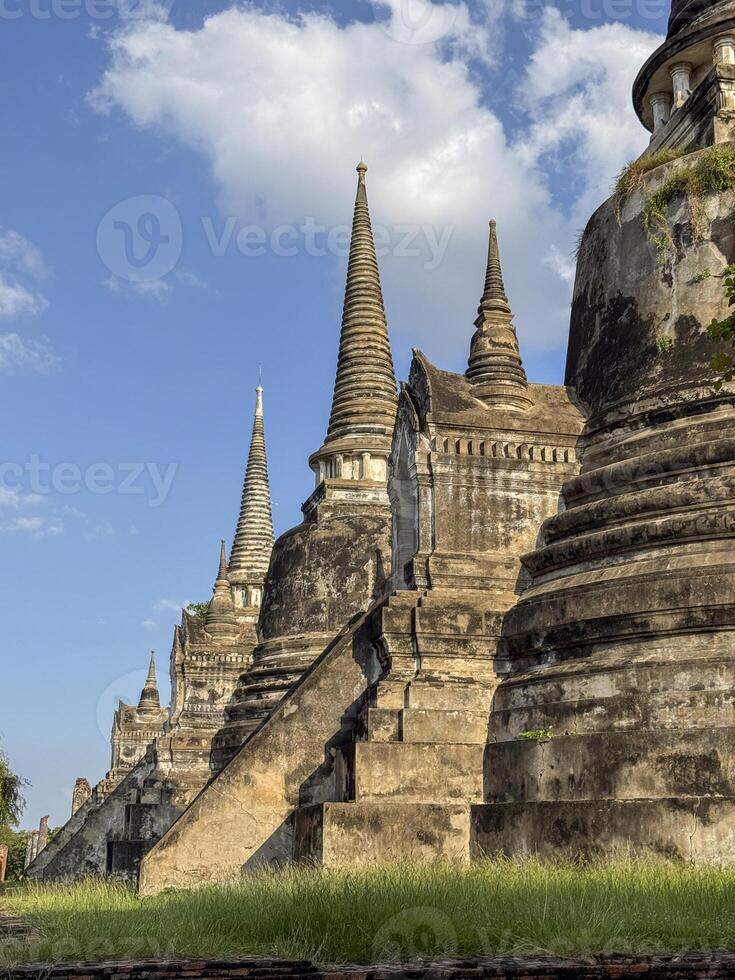 Wat Chaiwatthanaram Ayutthaya temple seen from river boat, ancient famous brick towers under a golden sunset. Traditional heritage, culture. Amazing majestic religious structure. photo
