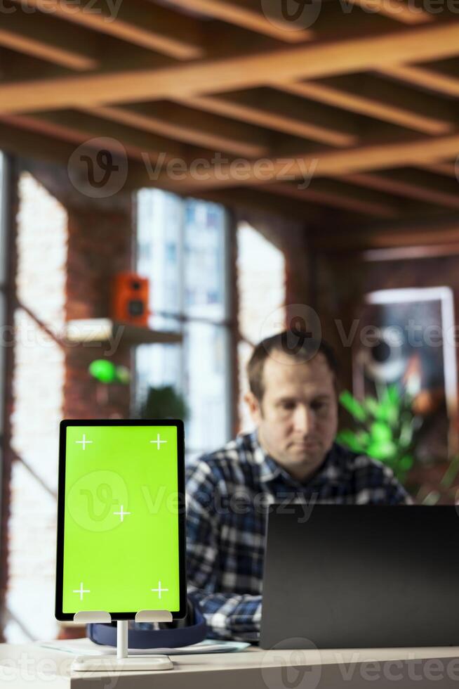 Close up of isolated screen tablet used by worker in home office analyzing data charts, identifying trends. Freelancer using chroma key device, compiling analytical reports, processing data photo