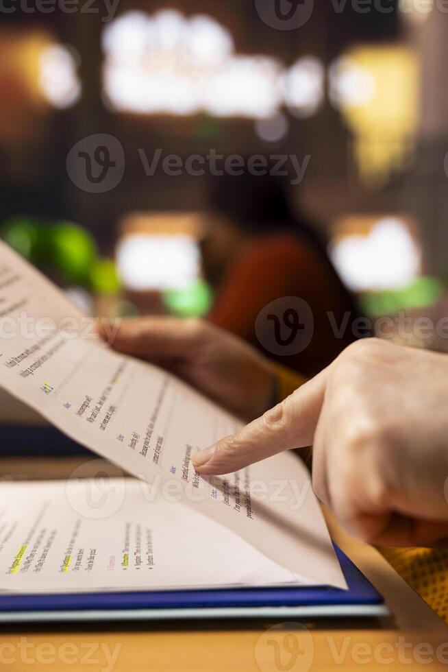 Senior pupil in a study area surrounded by library books and paperwork, preparing for university coursework and thesis writing, demonstrating learning and intellectual commitment. Close up. photo