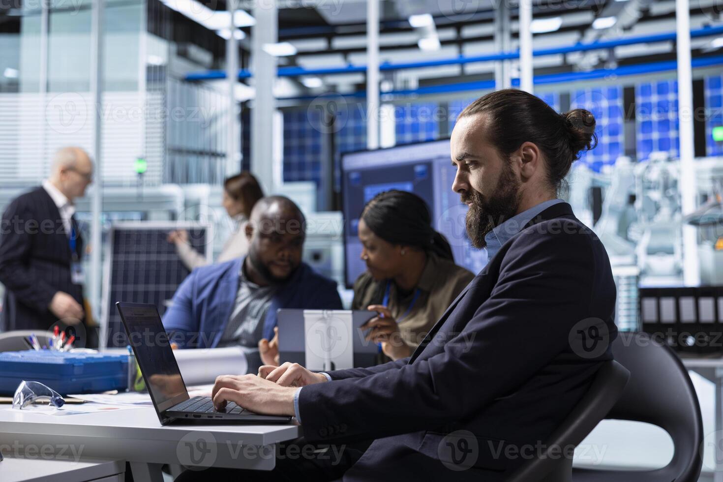Factory scientists doing research and development, working on manufacturing automation advancements. Industrial plant experts analyze technical data during meeting, doing strategic production planning photo