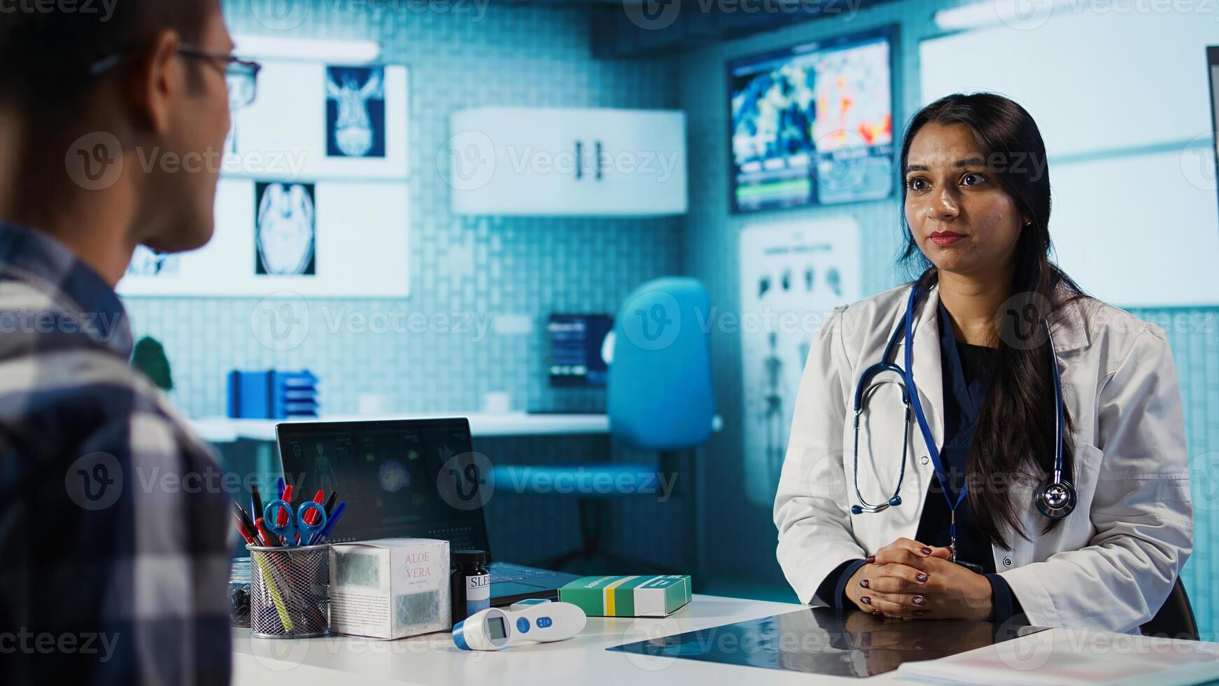 Medical expert and patient discussing diagnostic results in a modern cabinet, establishing advanced healthcare tools to present x ray imaging scans. Insurance management. Camera B. photo