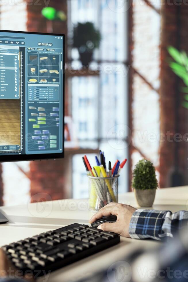 Interior designer uses architectural software to generate virtual photorealistic image renderings. Man preparing visual preview for customers after designing room with 3D modeling application photo