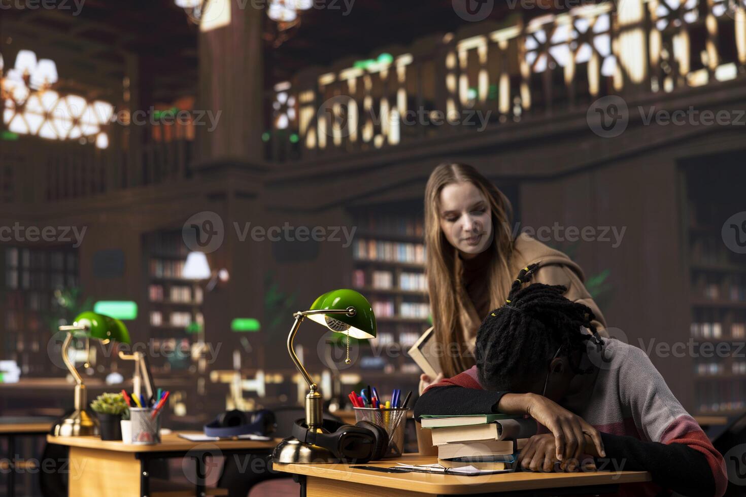 Person waking up african american girl in the university campus library, student falling asleep on her stack of borrowed books. Extremely tired and overwhelmed pupil tries to study all night. photo