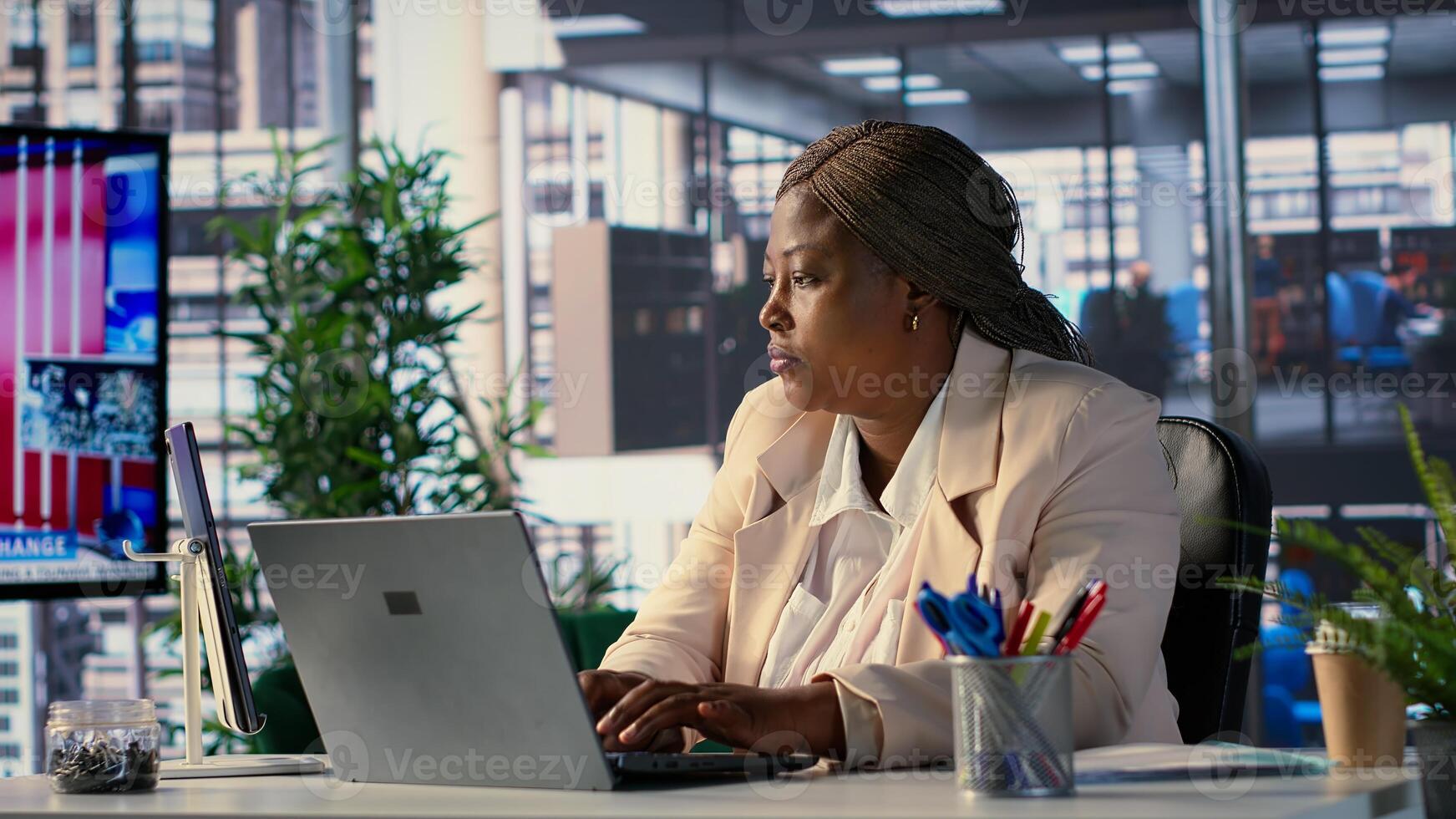 African american CEO driven by empowerment and ambition in her office, focuses on achieving business targets and enhancing company performance in a dynamic corporate setting. Success story. Camera A. photo