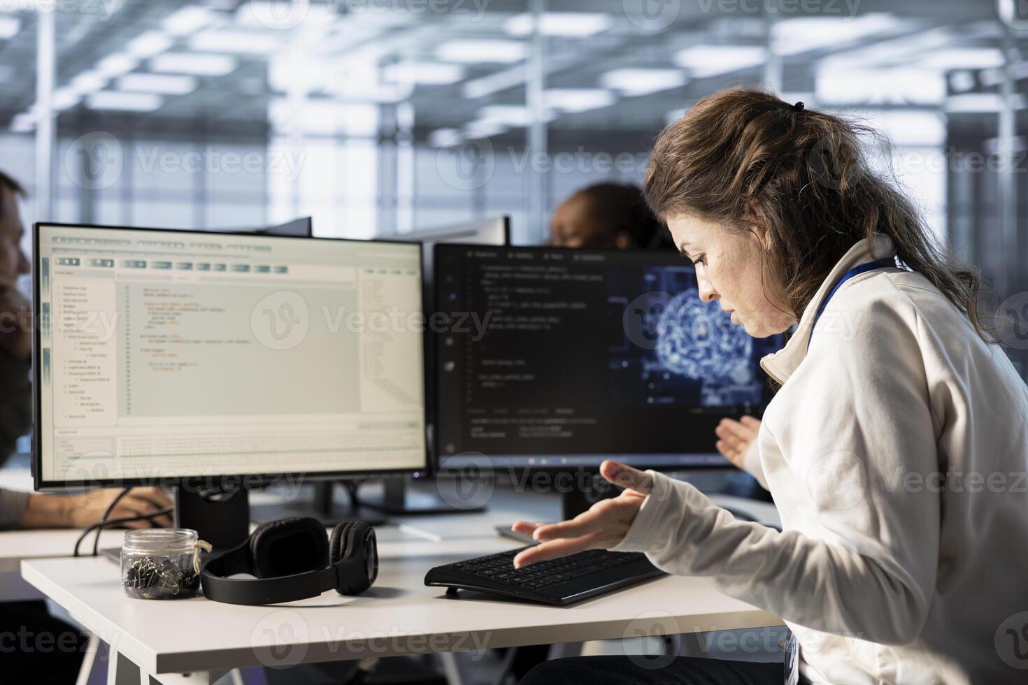 Frustrated technician annoyed after keyboard stopped working in data center while writing code on PC. Mad IT professional in server hub upset after computer peripherals got broken photo