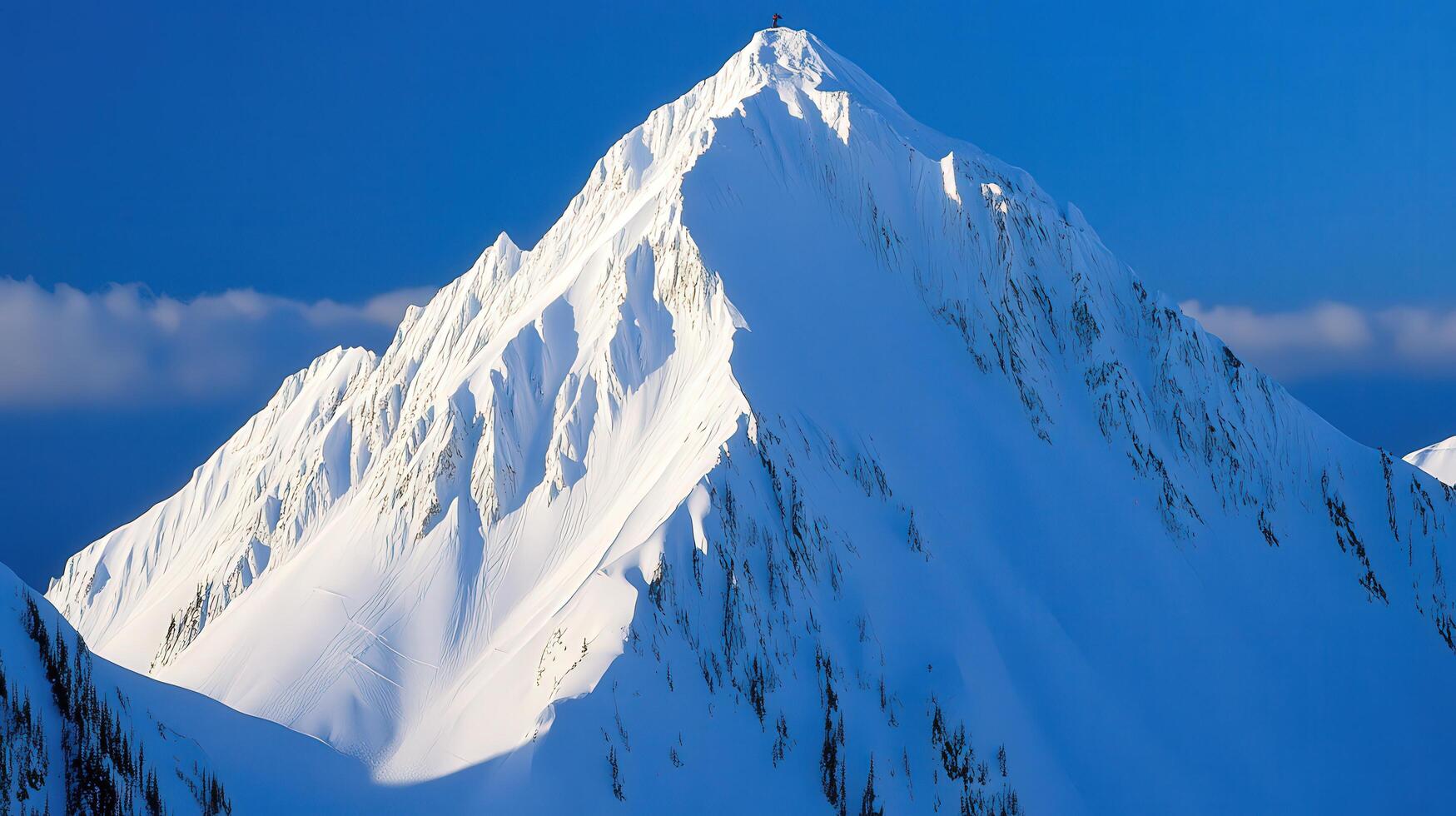 Majestic snow-capped mountain peak against a vibrant blue sky. photo