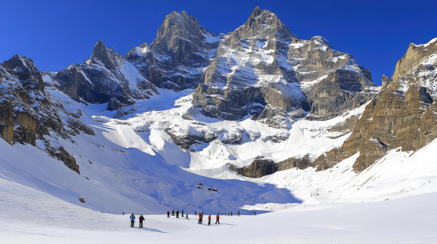 Snowy peaks and skiers in a dramatic winter landscape. photo