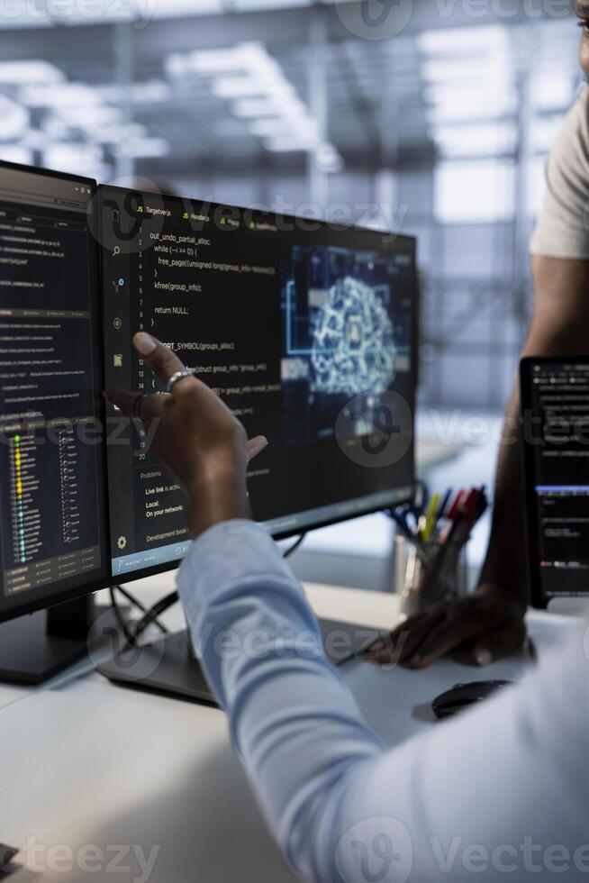 Computer scientists using machine learning applications to optimize server farm operations. Close up of IT professionals using PC to implement server virtualization in data center photo
