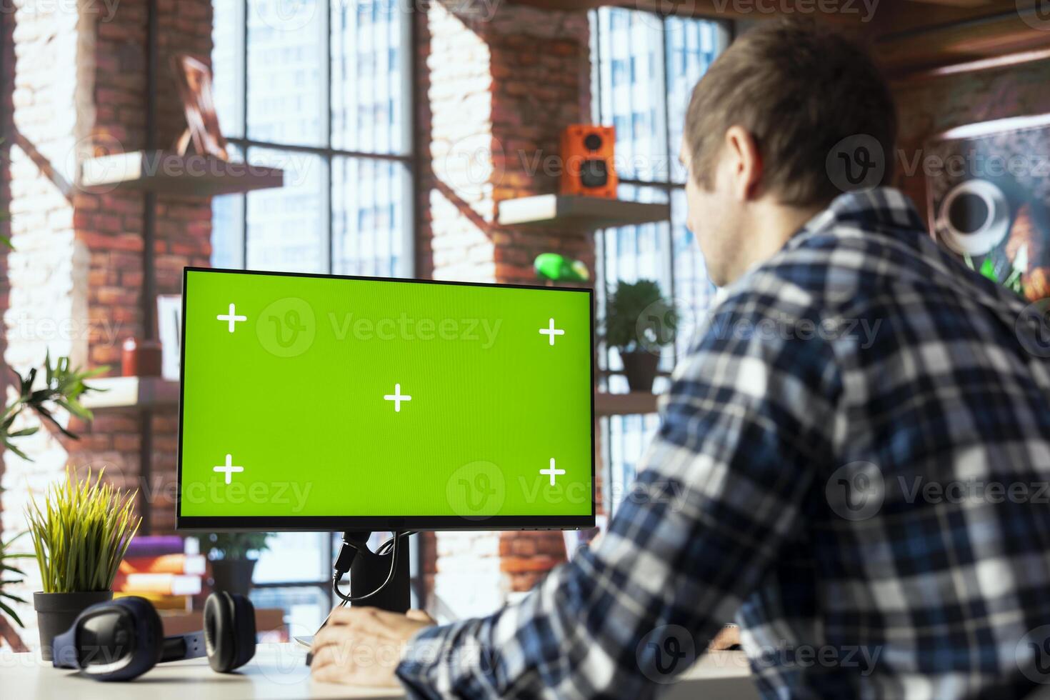 Employee seated at home office desk using green screen PC, checking emails displayed on screen, reading messages in inbox. Man managing electronic correspondence on mockup computer photo