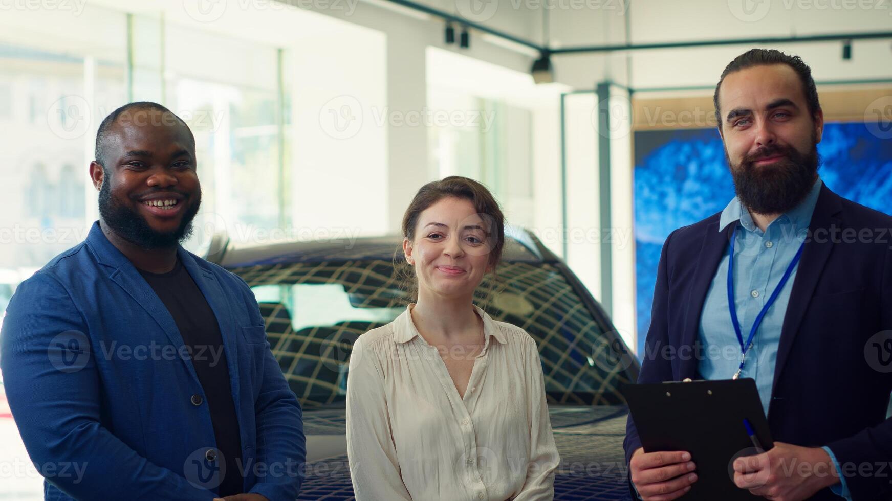 Portrait of cheerful salesman closing deal with customers after negotiating price and extra car features. Happy showroom agent shaking hands with clients after persuading to make purchase, camera A photo