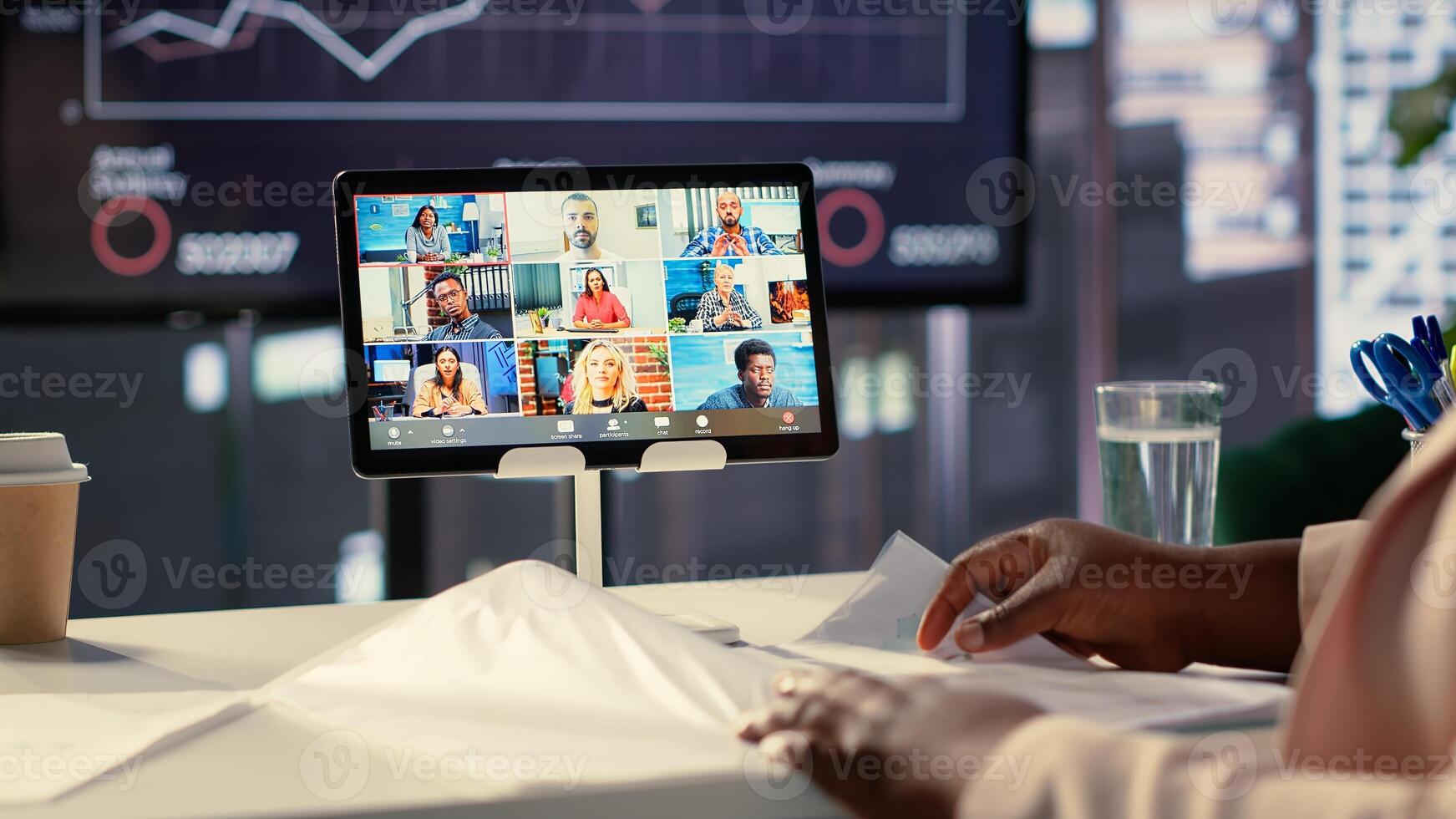 African american CEO sharing sales insight on videocall with forecast affiliates, discussing about profit and analytics in a high end office. Entrepreneur looking to expand her enterprise. Camera A. photo