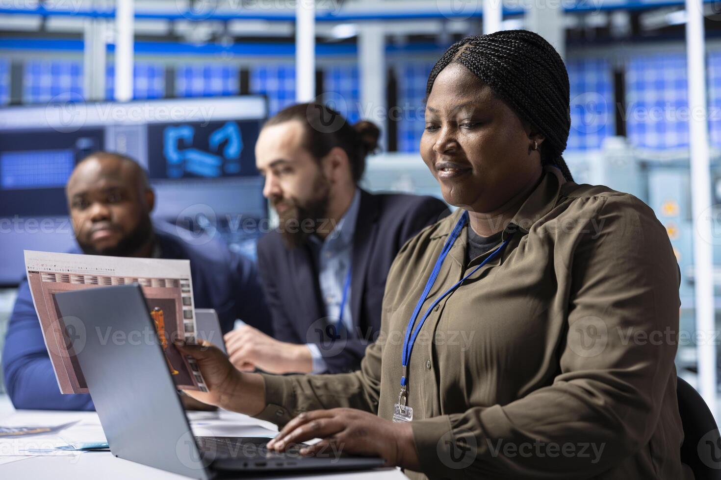 Industrial plant researchers using notebook for research and development data analysis. Factory engineering team members working together to research innovative photovoltaic materials using laptop photo