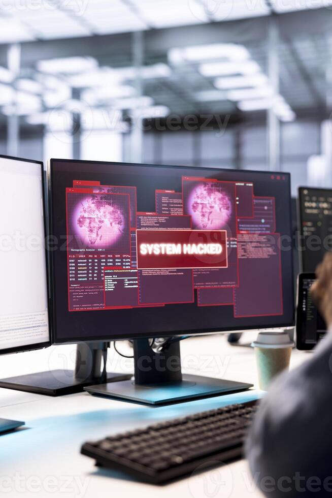System administrator in server hub working to protect equipment from hacker. Close up of IT worker in data center establishment in need of help from engineers to fix security breach alert photo