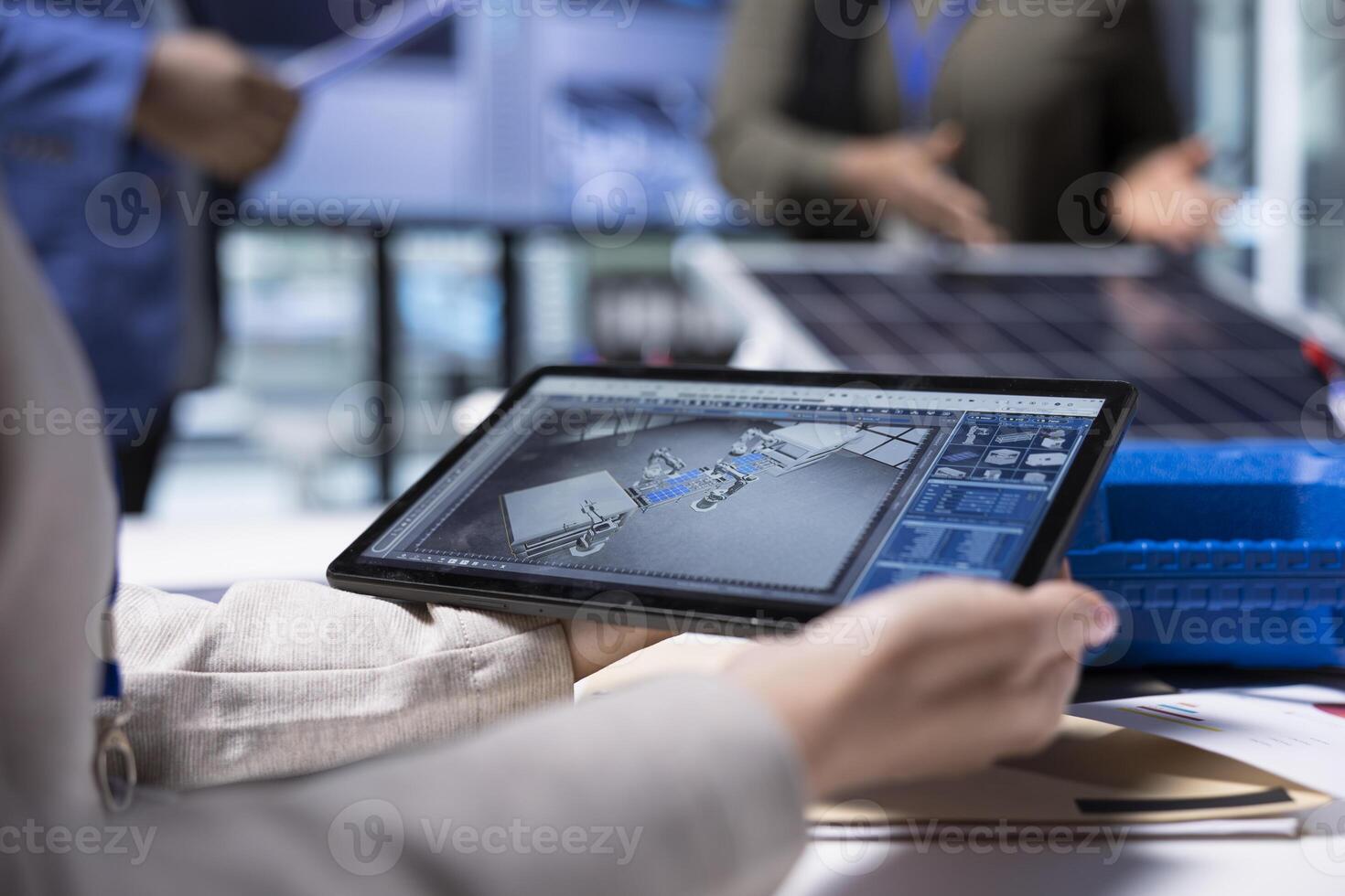 Photovoltaics factory manager visualizes factory floor designs with 3D software tools on tablet. Solar panels plant businessperson looking at computer simulations in CAD program on device photo
