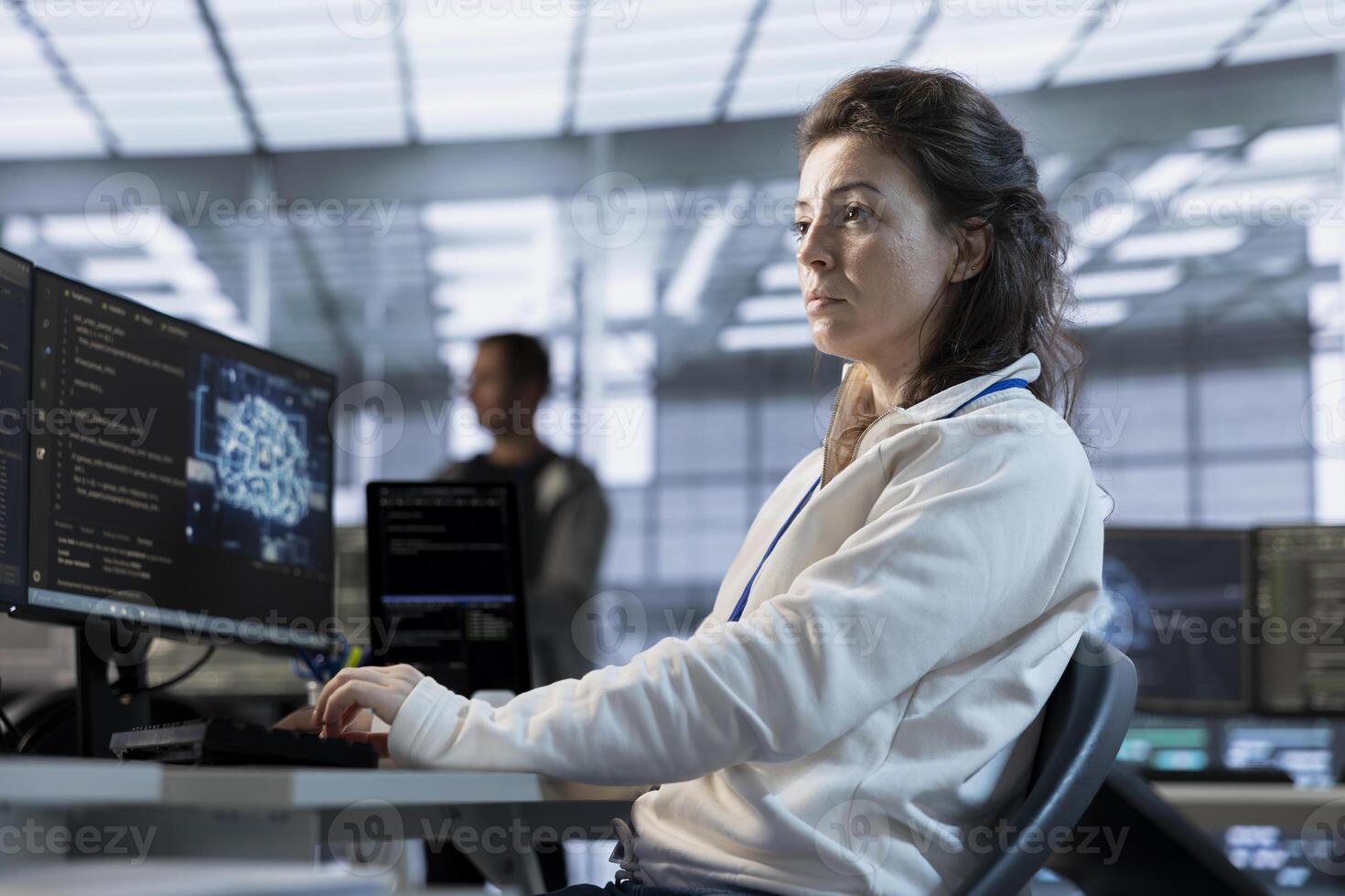 System administrator using artificial intelligence technology to optimize data center performance. Server room expert using AI tech to streamline operations and accurately forecast potential issues photo