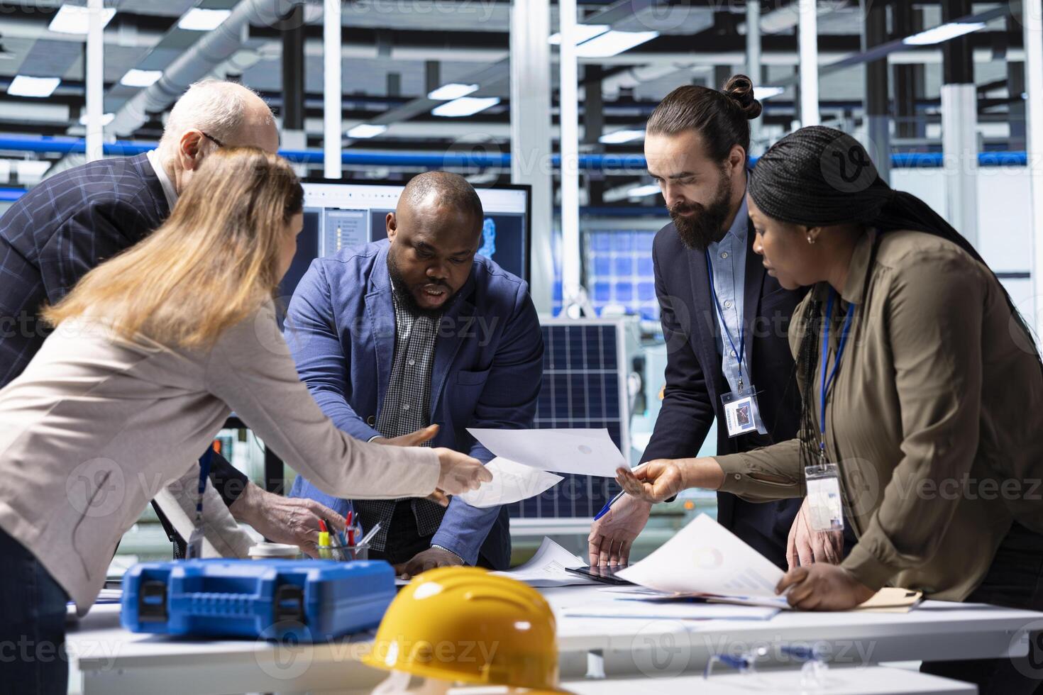 Industrial plant shareholders conducting research on potential investment opportunities, reading paperwork. Factory shareholders doing competitor analysis, identifying trends, looking over files photo