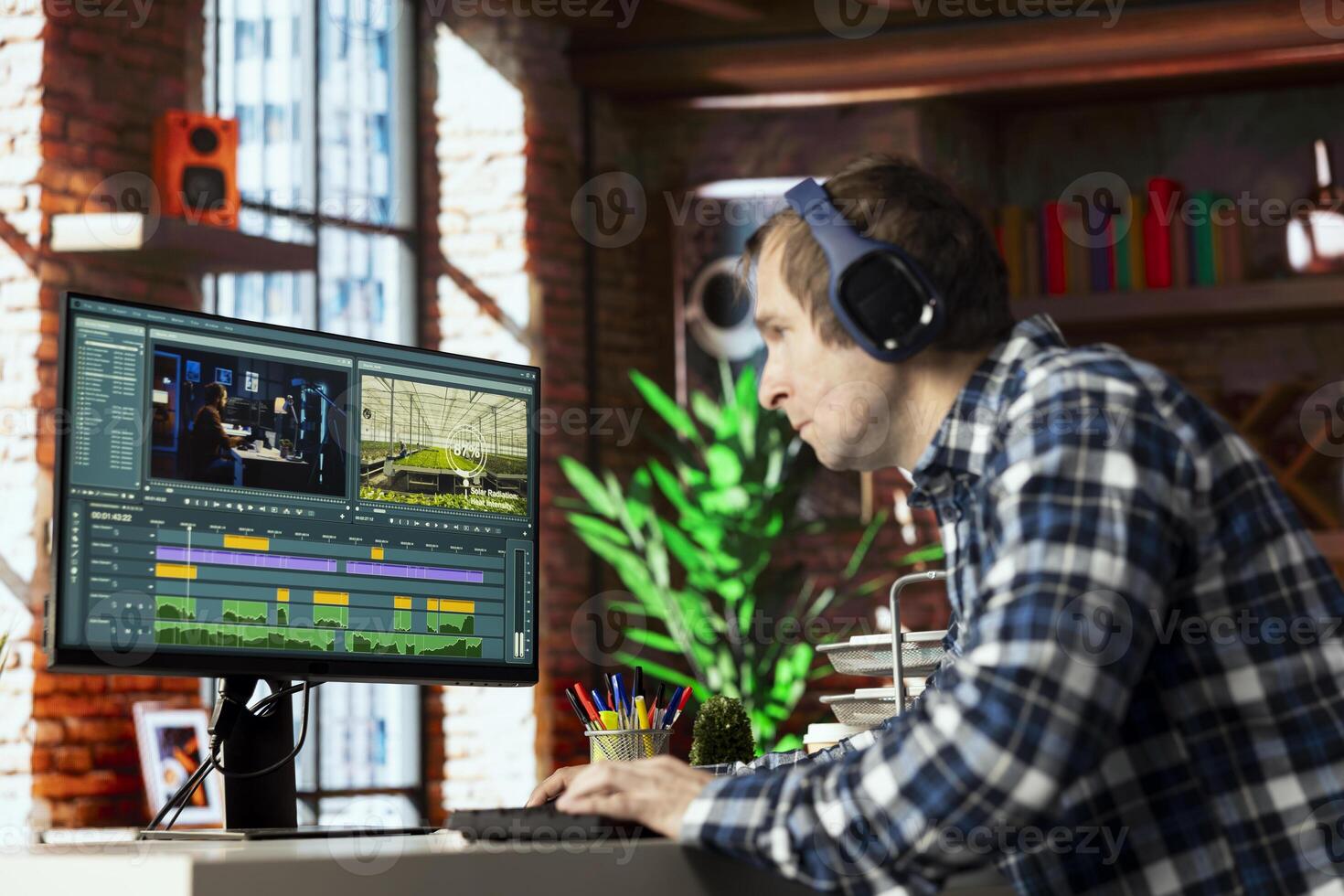 editor wearing headphones doing montage, using specialized software application. Freelancer in home office using editing tools on PC to cut movie project footage photo