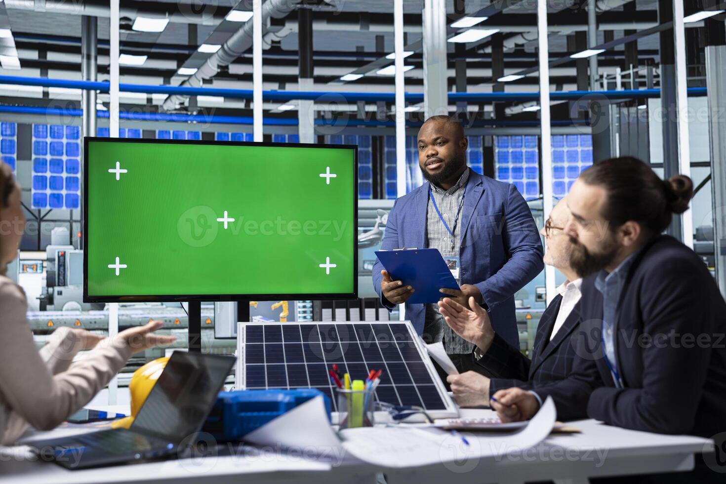 Businessmen using mockup display to show solar panels designs research data analysis. Factory specialists looking at green screen monitor, researching innovative photovoltaic materials in office photo