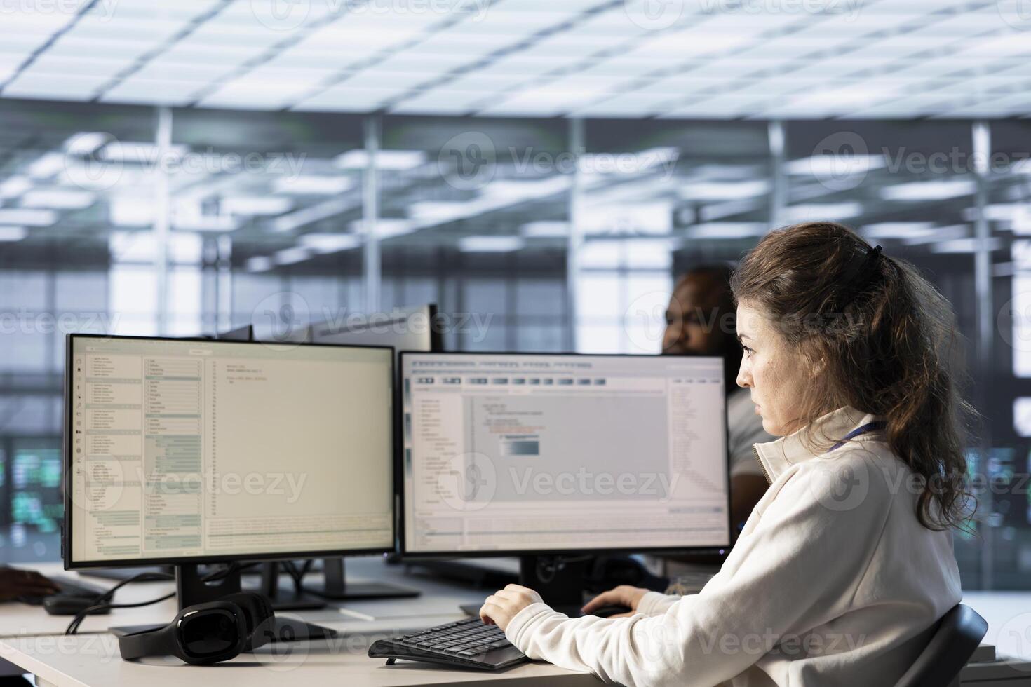 Admins doing yearly checkup to prolong data center electronics life span and avoid downtime. Computer scientists in server room monitoring server infrastructure components photo