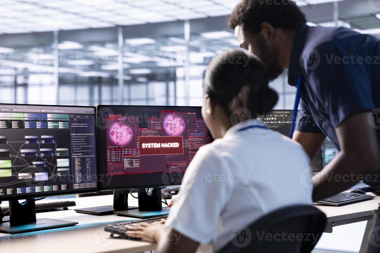 African american engineer in server hub helped by manager to investigate breach alerts, working to protect equipment from hacker. Employee requesting aid from supervisor to mitigate security risks photo