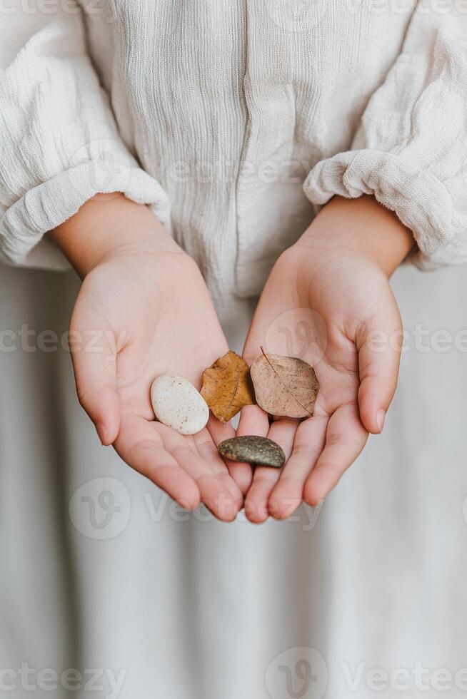 Hands of a young girl exploring textures of natural objects in an educational setting photo