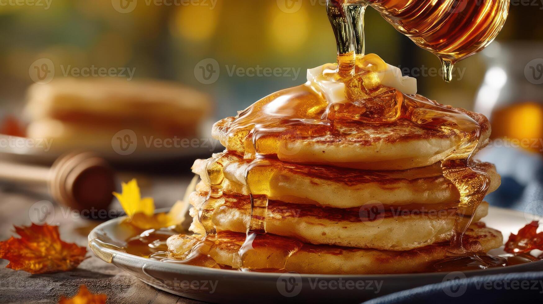 Stack of pancakes drizzled with maple syrup, autumn leaves. photo