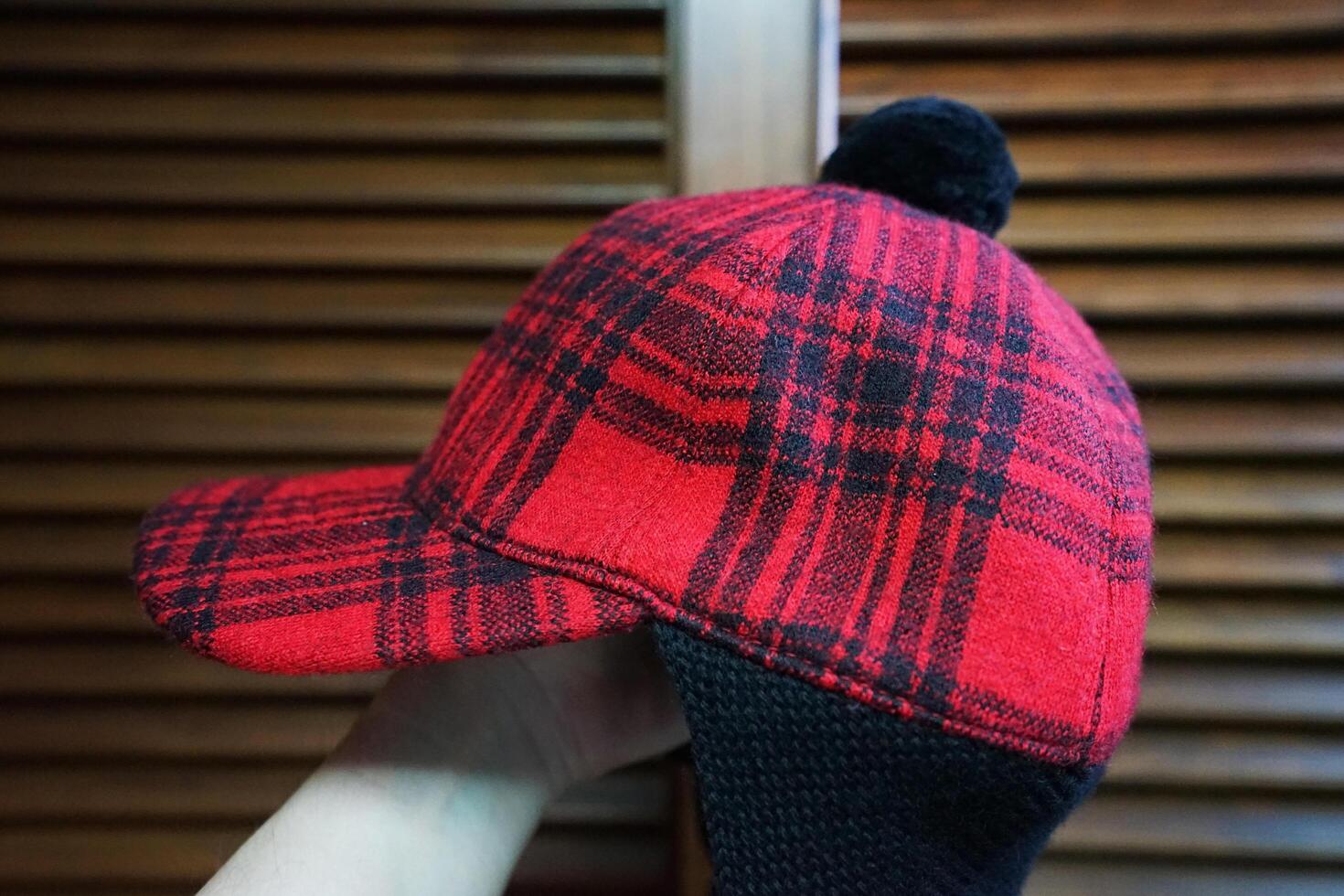 'GUCCI' logo tag and detail of red and black buffalo check winter hat photo