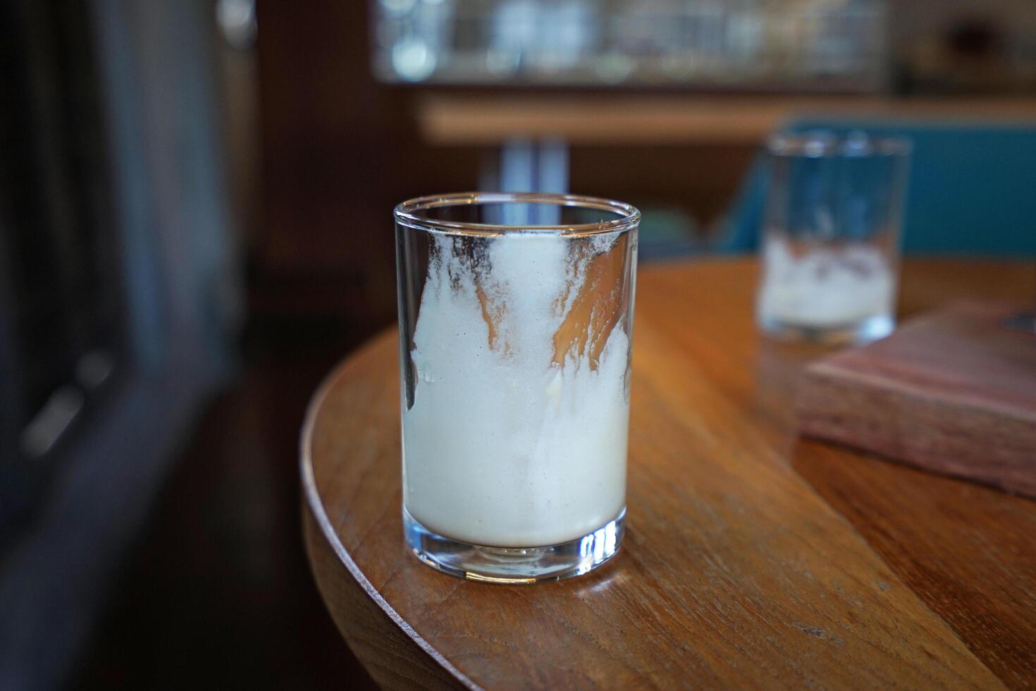 Empty glass left on wooden tray table photo