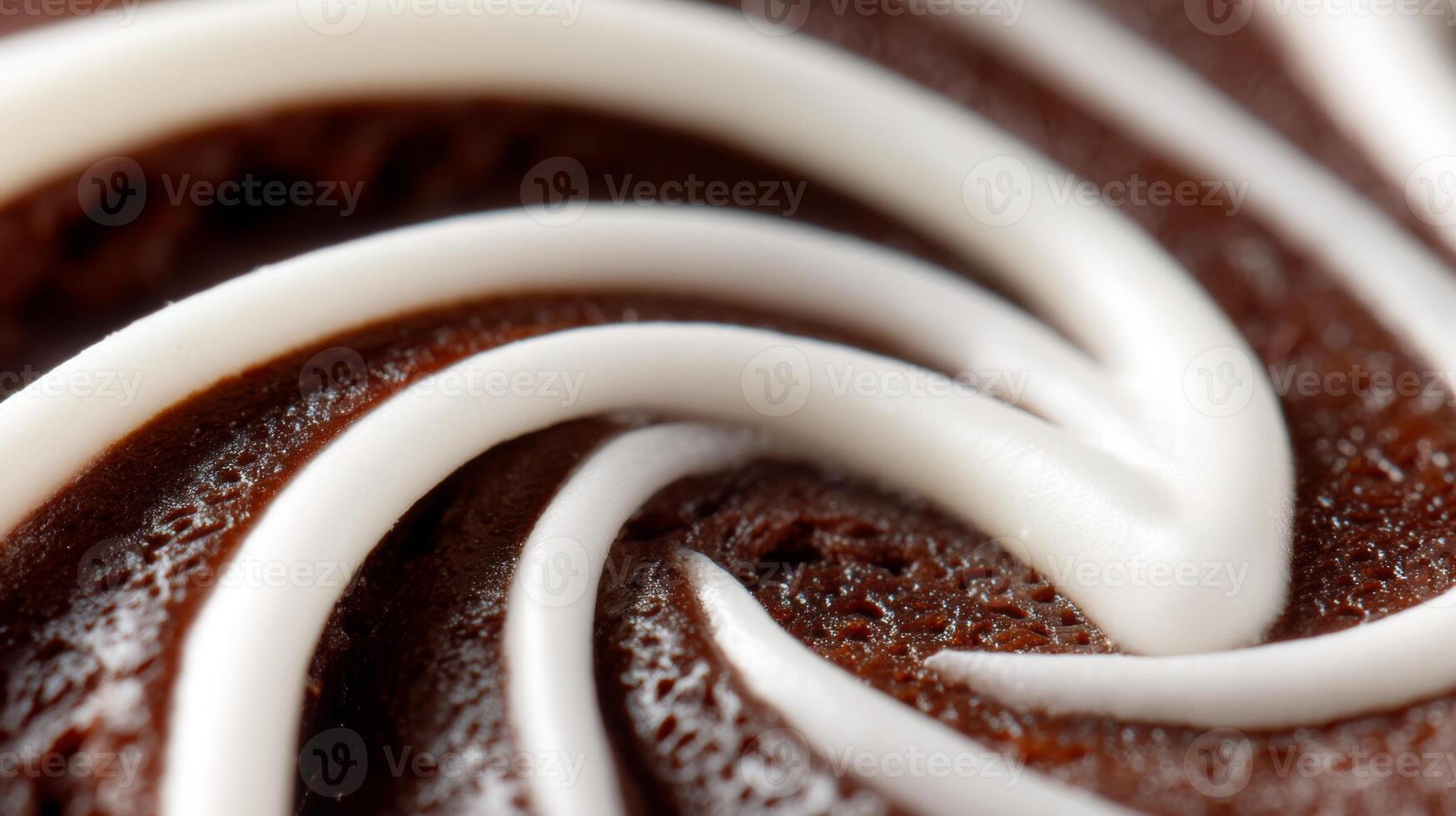 Close-up Detail of Rich Chocolate Frosting with Intricate Swirls and Creamy White Design on a Delicious Dessert Treat photo